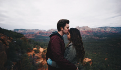 man kissing woman's forehead