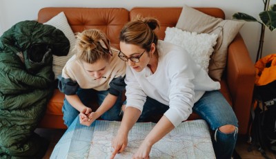A Woman and a Girl Looking at the Paper Map