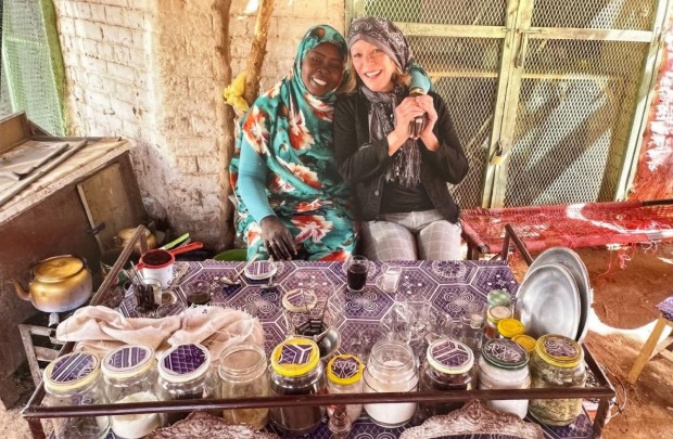 Hospitali-tea: Franci Neely enjoying Sudanese coffee with ginger, black pepper, and cardamon with a new friend in Karima, Sudan